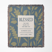 Woven blanket with floral pattern and 'Blessed' text on a blue background