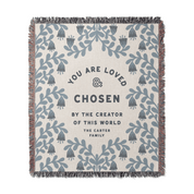 Blanket with floral pattern and text 'You are loved & chosen by the creator of this world. The Carter Family' on a white background.