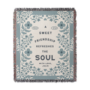 Floral-patterned blanket with text on a white background