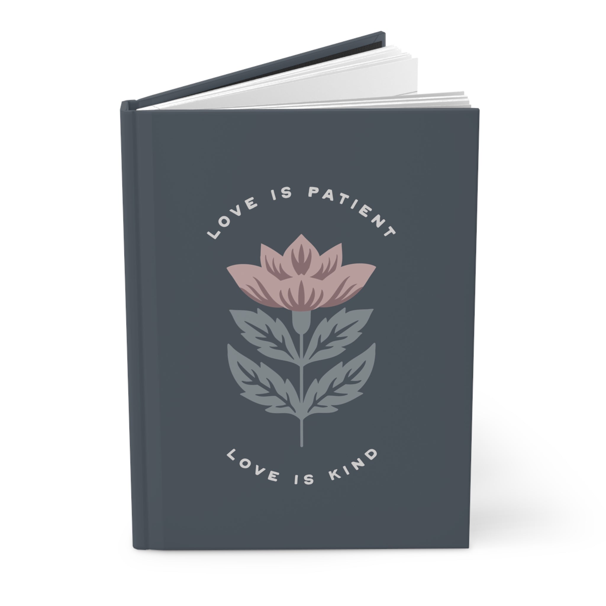 Notebook with floral design and text 'Love is Patient, Love is Kind' on a white background