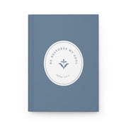Blue notebook with a white circular design and text on a white background