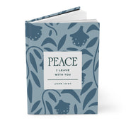 Notebook with blue leaf pattern and 'Peace I Leave With You' text on a white background