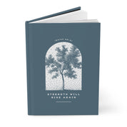Blue notebook with tree design and 'Strength Will Rise Again' text on a white background