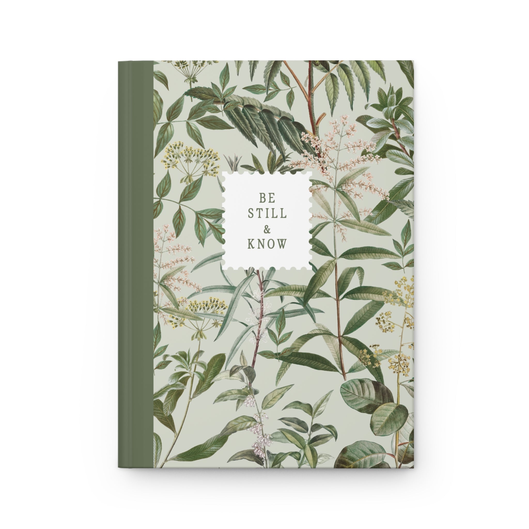 Notebook with green leaf pattern and 'Be Still & Know' text on a white background