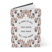Notebook with floral design and motivational quote on a white background