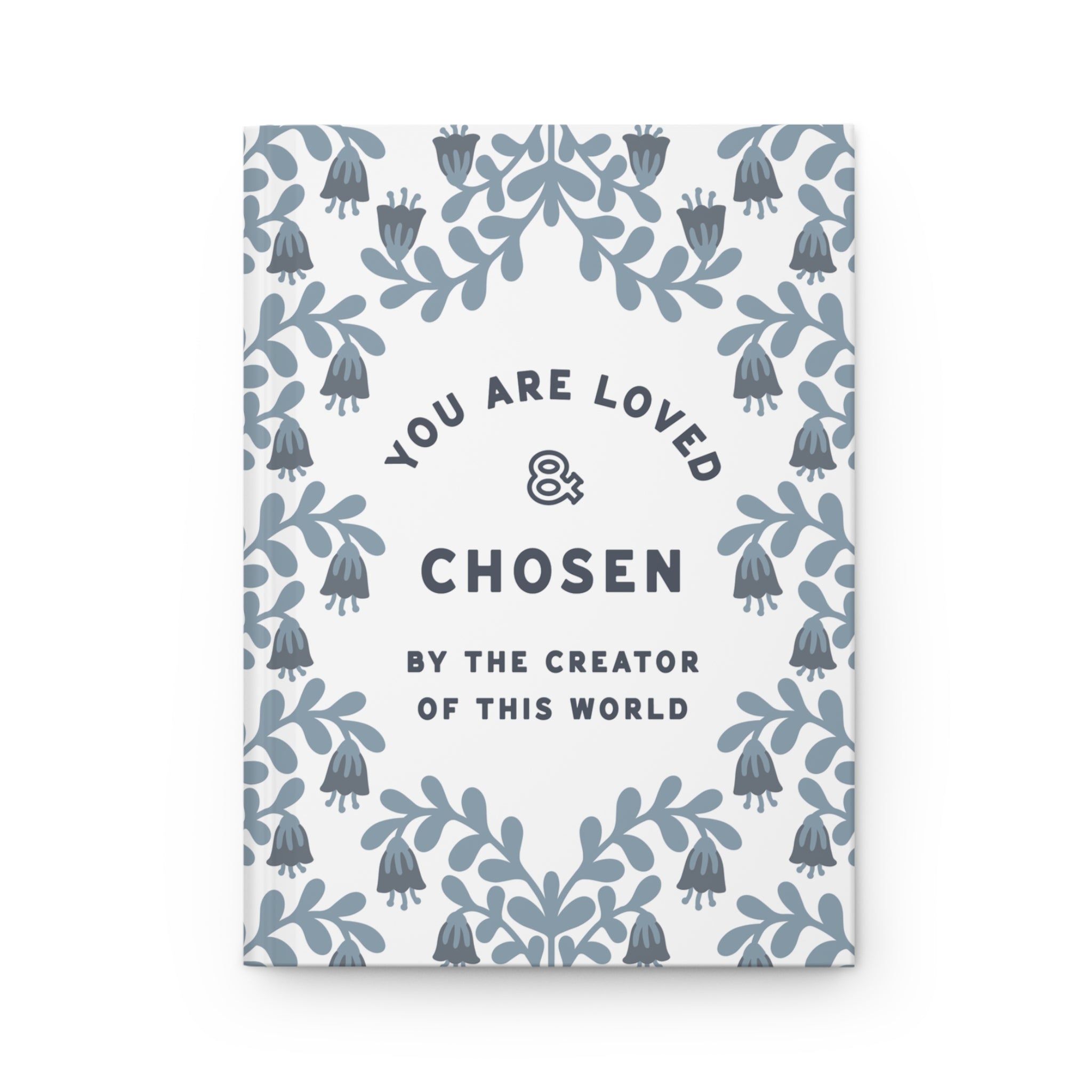 Notebook with floral design and motivational text on a white background