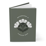 Gray notebook with floral design and text on a white background