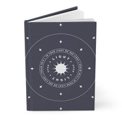 Dark blue notebook with white circular design and text on a white background