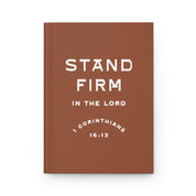 Brown notebook with 'Stand Firm in the Lord' text on a white background