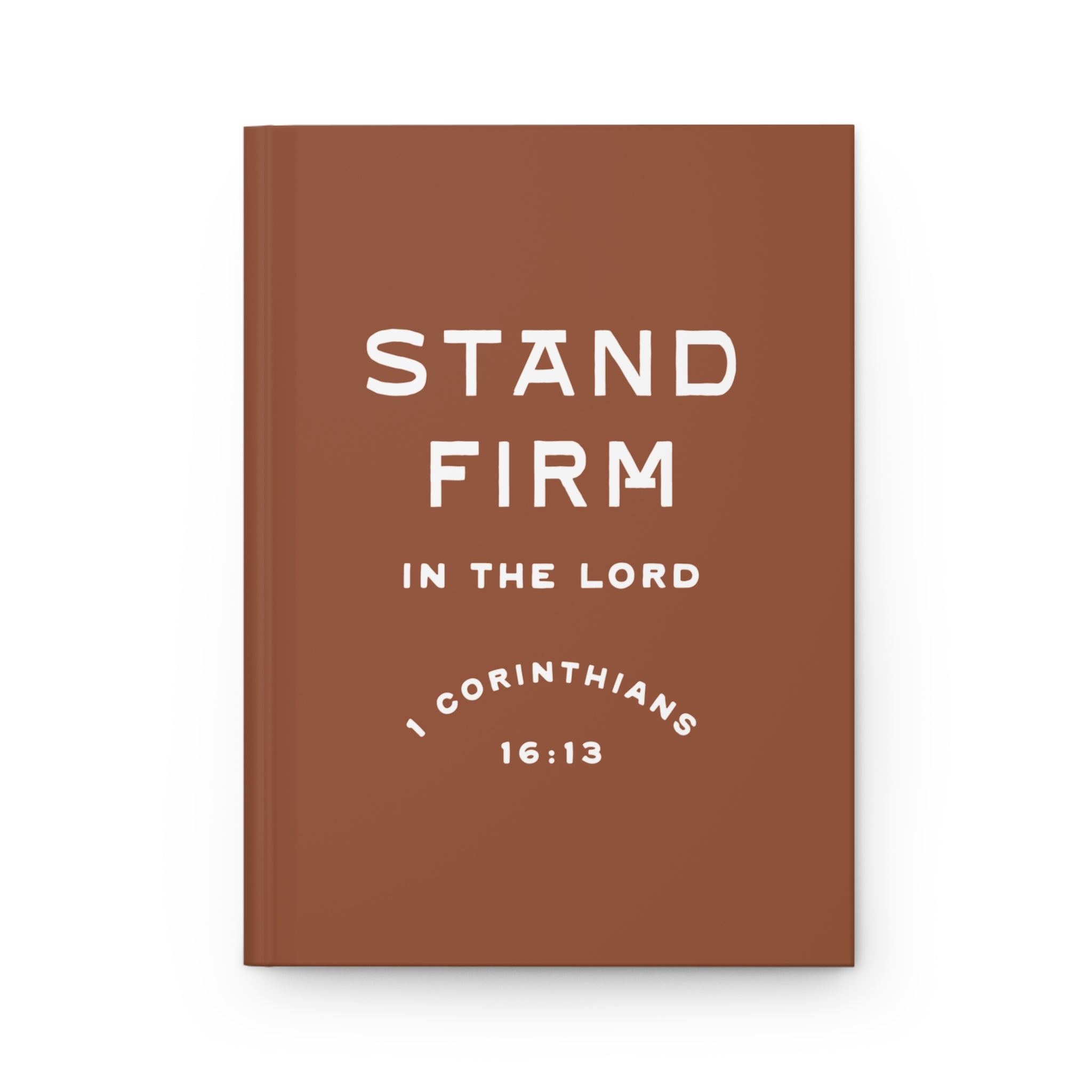Brown notebook with 'Stand Firm in the Lord' text on a white background
