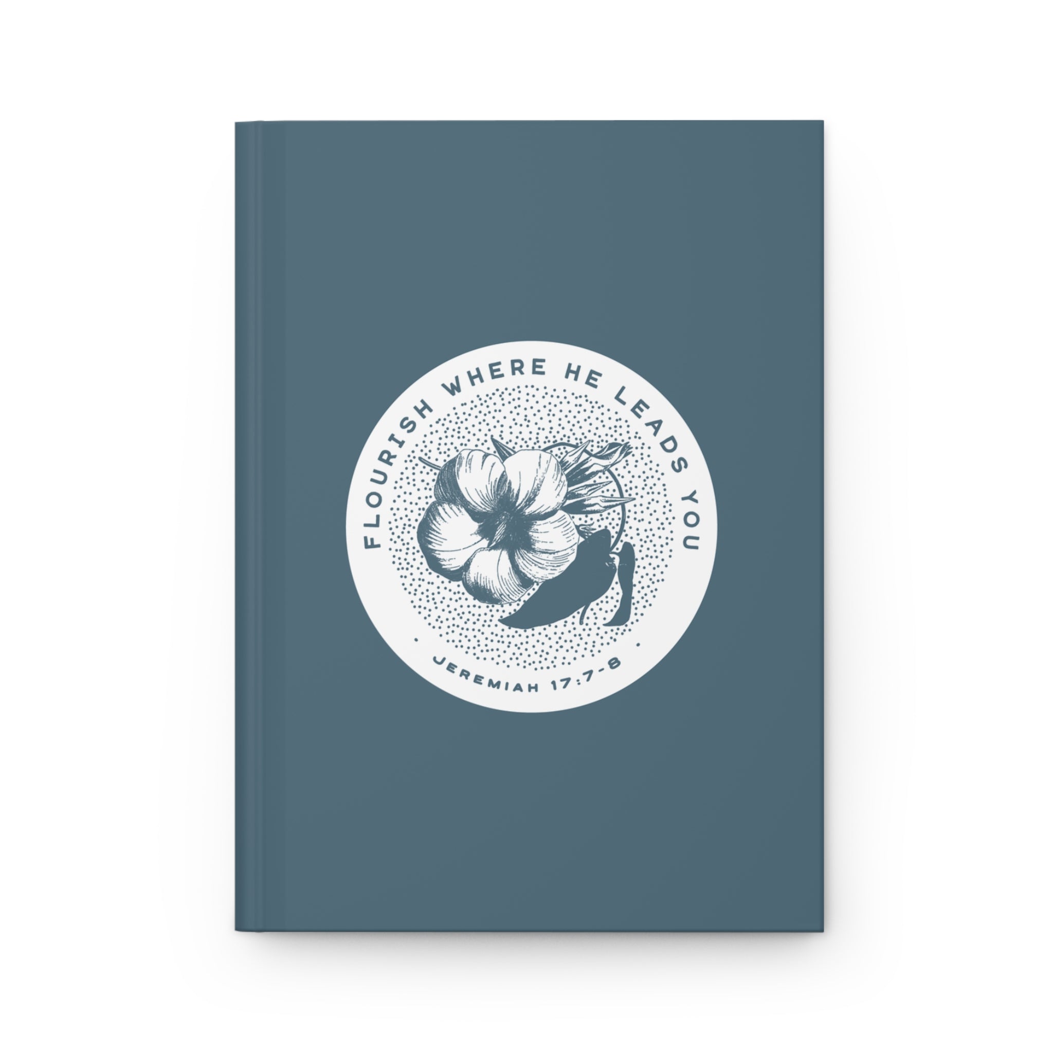 Blue notebook with floral design and text on a white background