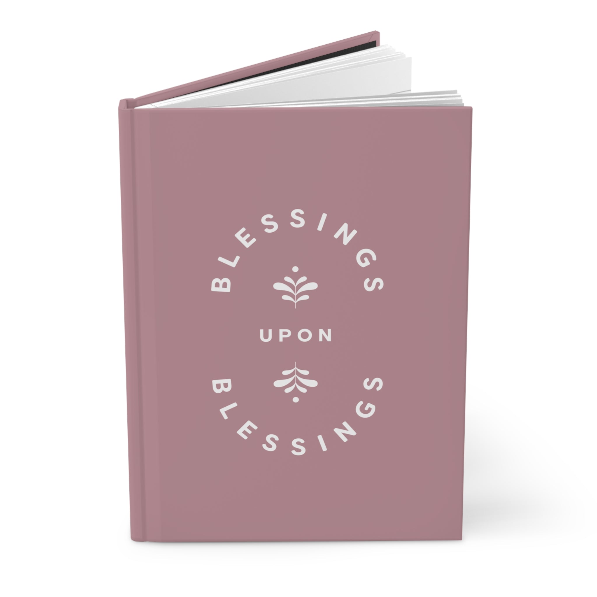 Pink notebook with 'Blessings Upon Blessings' text on a white background