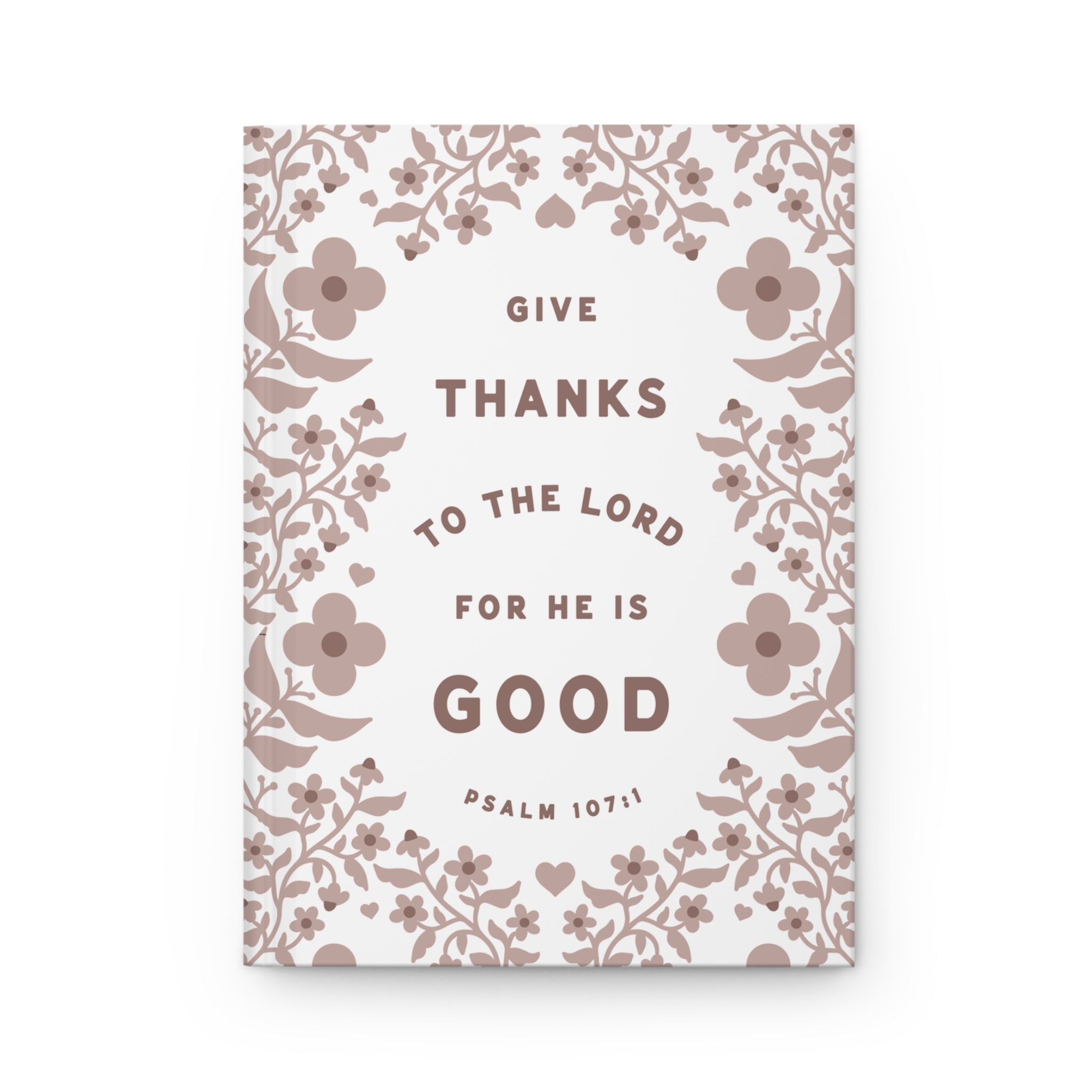 Notebook with floral design and text 'Give thanks to the Lord for he is good' on a white background