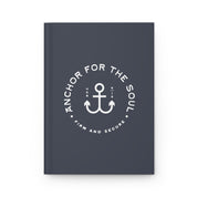 Dark blue notebook with white anchor design and text on a white background