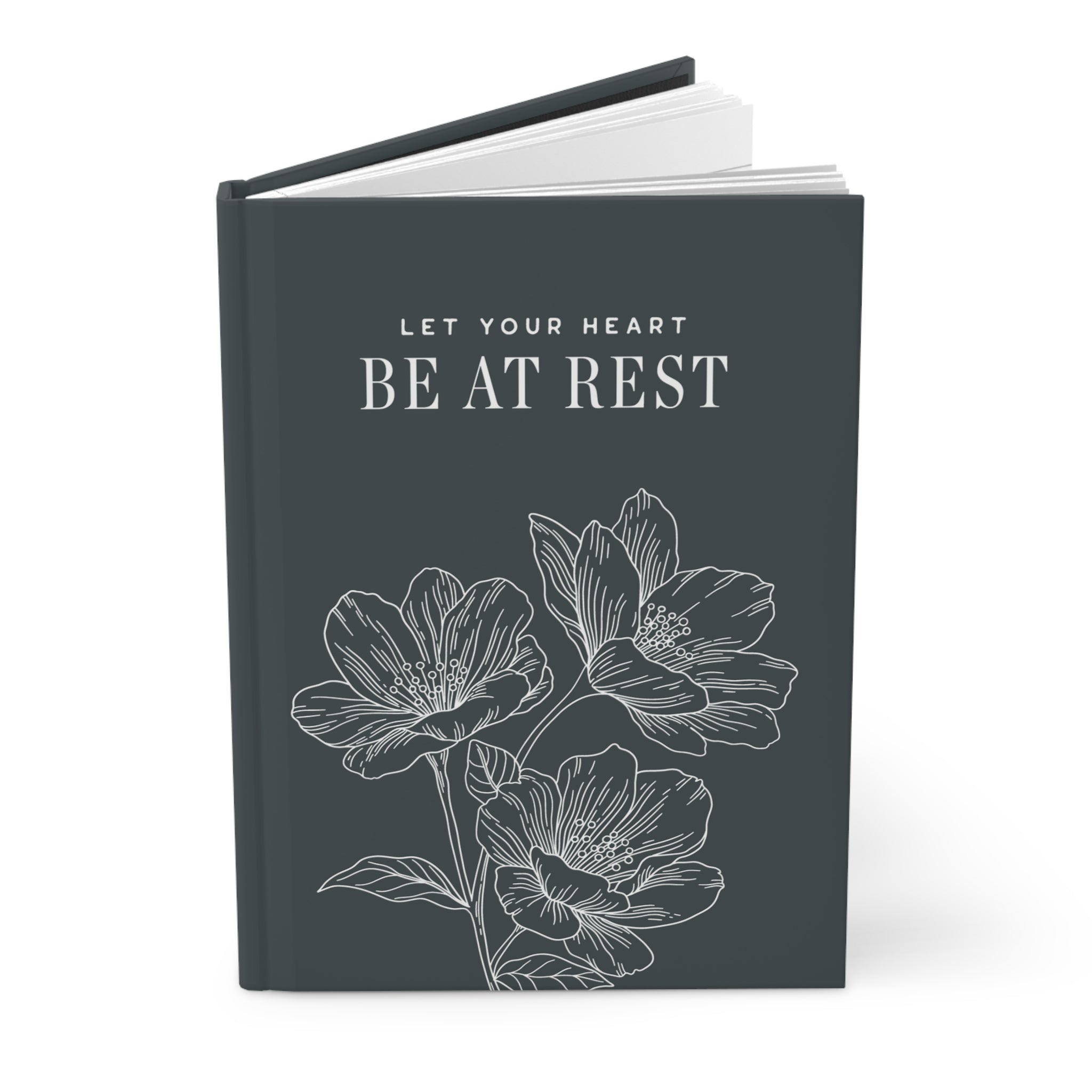 Book with floral design and text 'Let your heart be at rest' on a white background