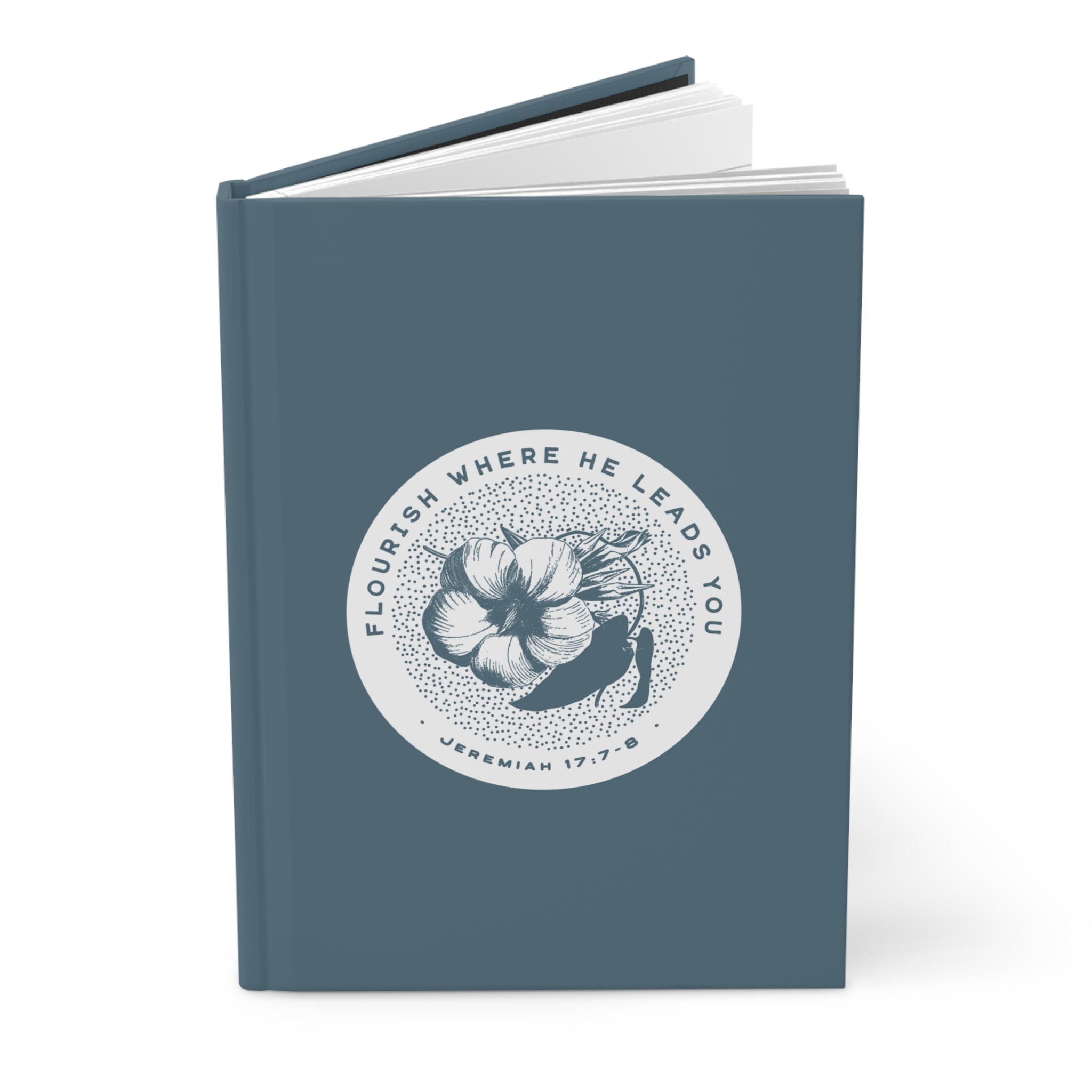 Blue notebook with a circular design featuring a flower and text on a white background