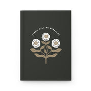 Black notebook with floral design and 'There Will Be Miracles' text on a white background