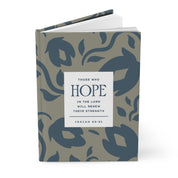 Book with floral pattern and motivational quote on a white background