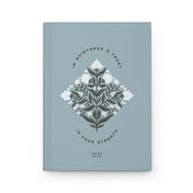 Book with floral design and text on a light blue background