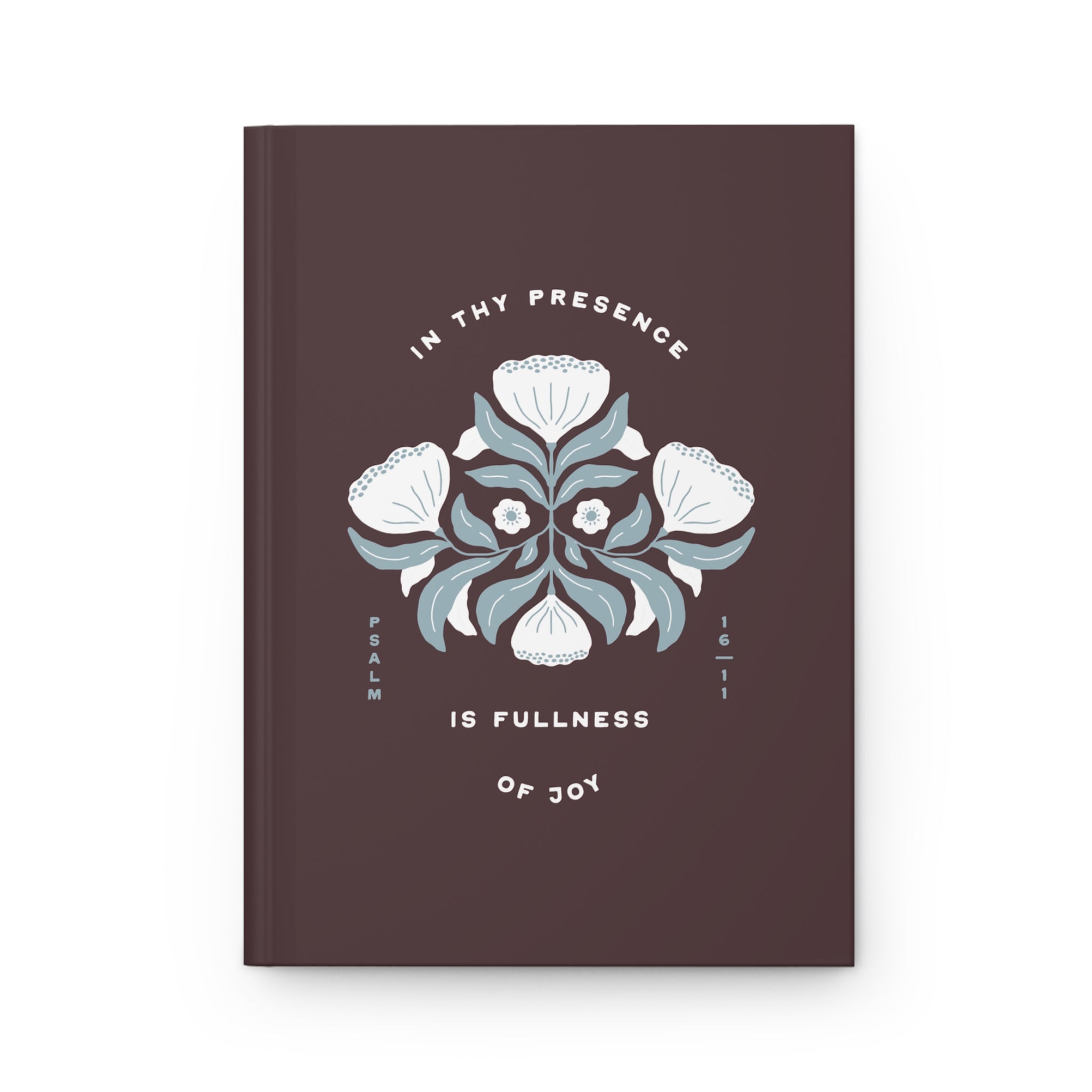 Brown notebook with floral design and text on a white background