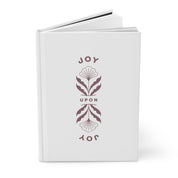 White book with decorative text and floral design on a white background