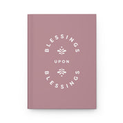 Pink notebook with 'Blessings Upon Blessings' text on a white background