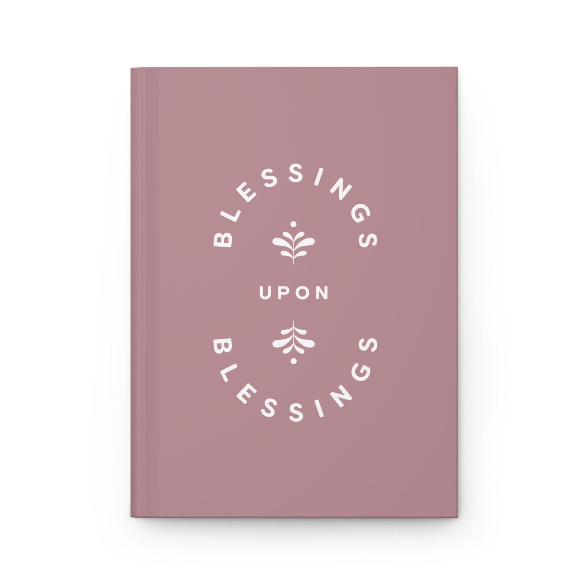Pink notebook with 'Blessings Upon Blessings' text on a white background
