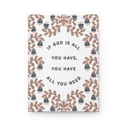 Notebook with floral design and motivational quote on a white background