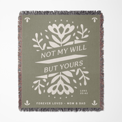 Green blanket with white floral design and text on a white background
