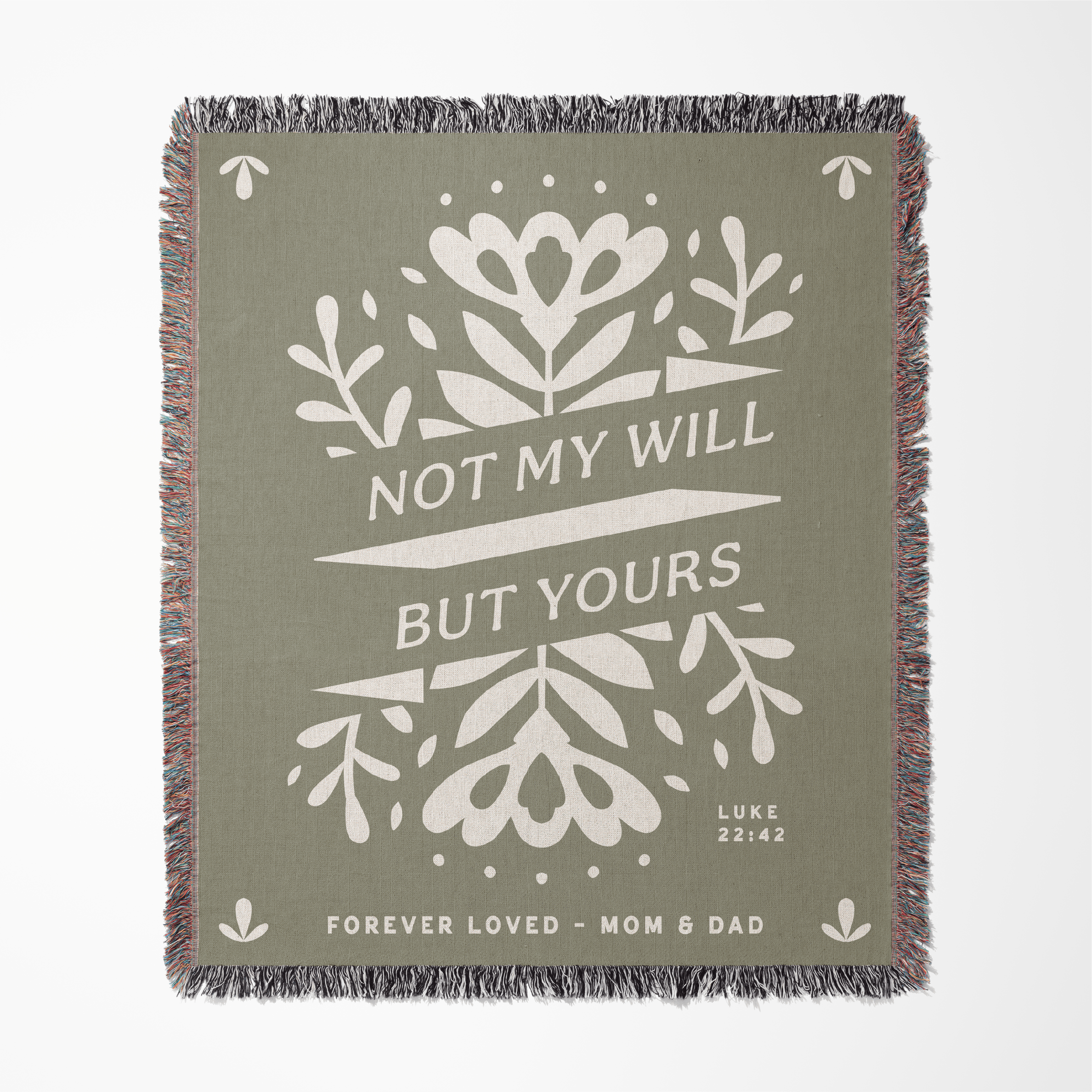 Green blanket with white floral design and text on a white background