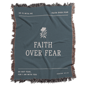 Teal blanket with 'Faith Over Fear' text and floral design on a white background