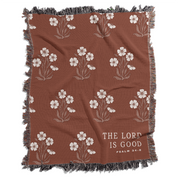 Brown blanket with floral patterns and 'The Lord is Good' text on a white background