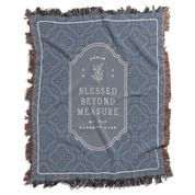 Blue patterned throw blanket with 'Blessed Beyond Measure' text on a white background
