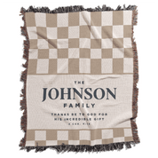 Checkered blanket with 'The Johnson Family' text on a white background