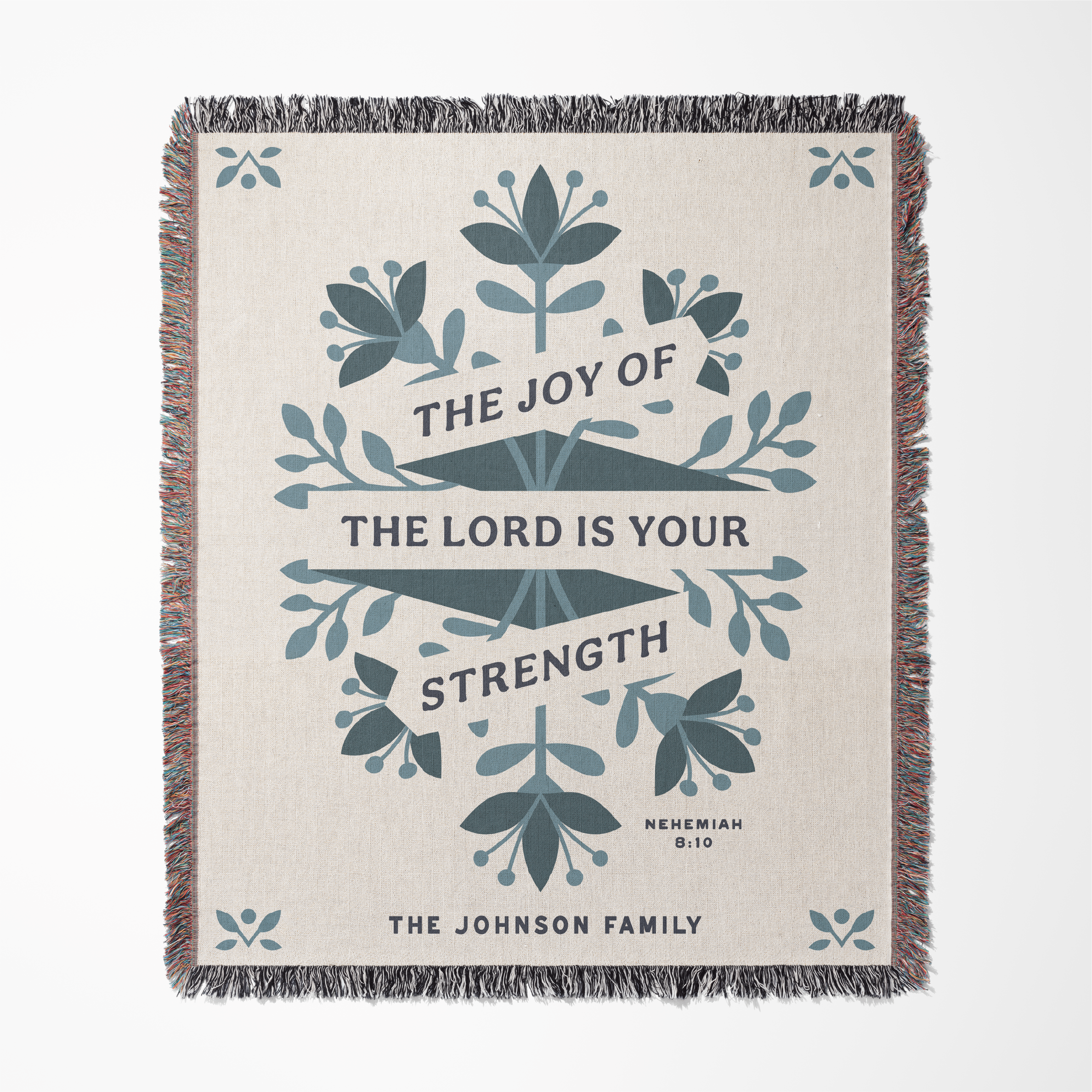 Woven blanket with decorative text and floral patterns on a white background