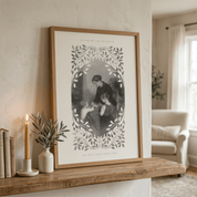 A framed black-and-white vintage-style print leaning on a wooden mantel in a softly lit living room. The print features an ornate leafy border and the text 'AS FOR ME AND MY HOUSE WE WILL LEAVE THE LORD' and 'WE WILL NOT SURRENDER THE LORD.