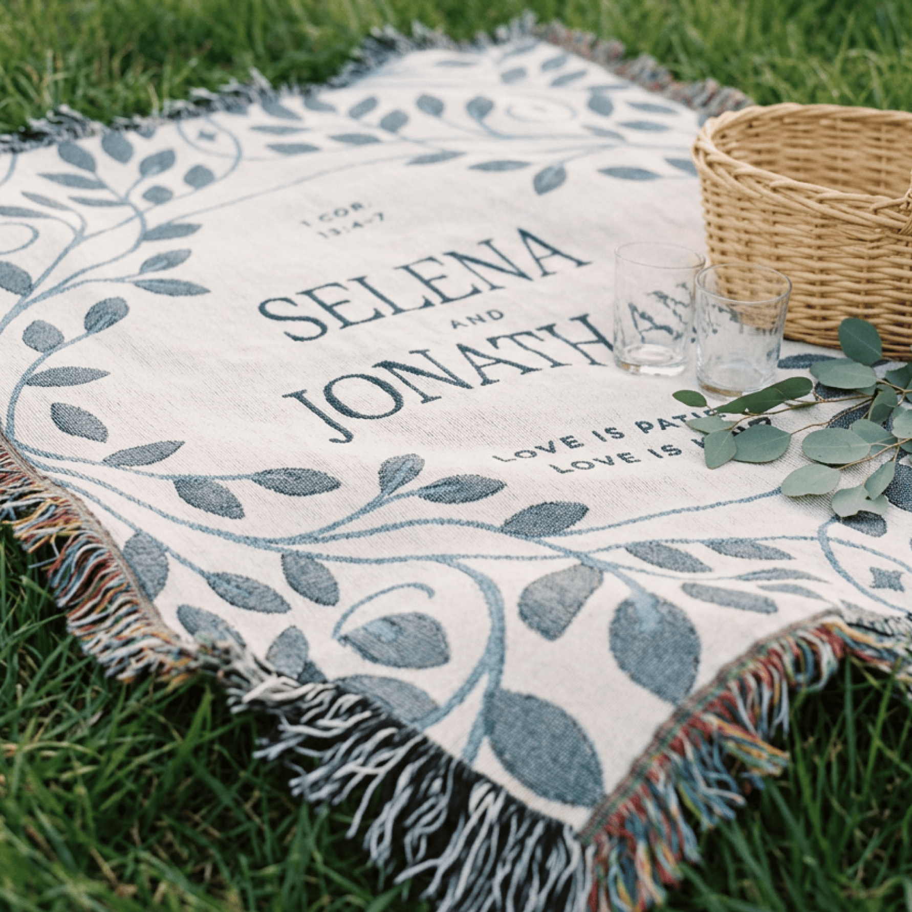 Personalized picnic blanket with names and leaf design on grass