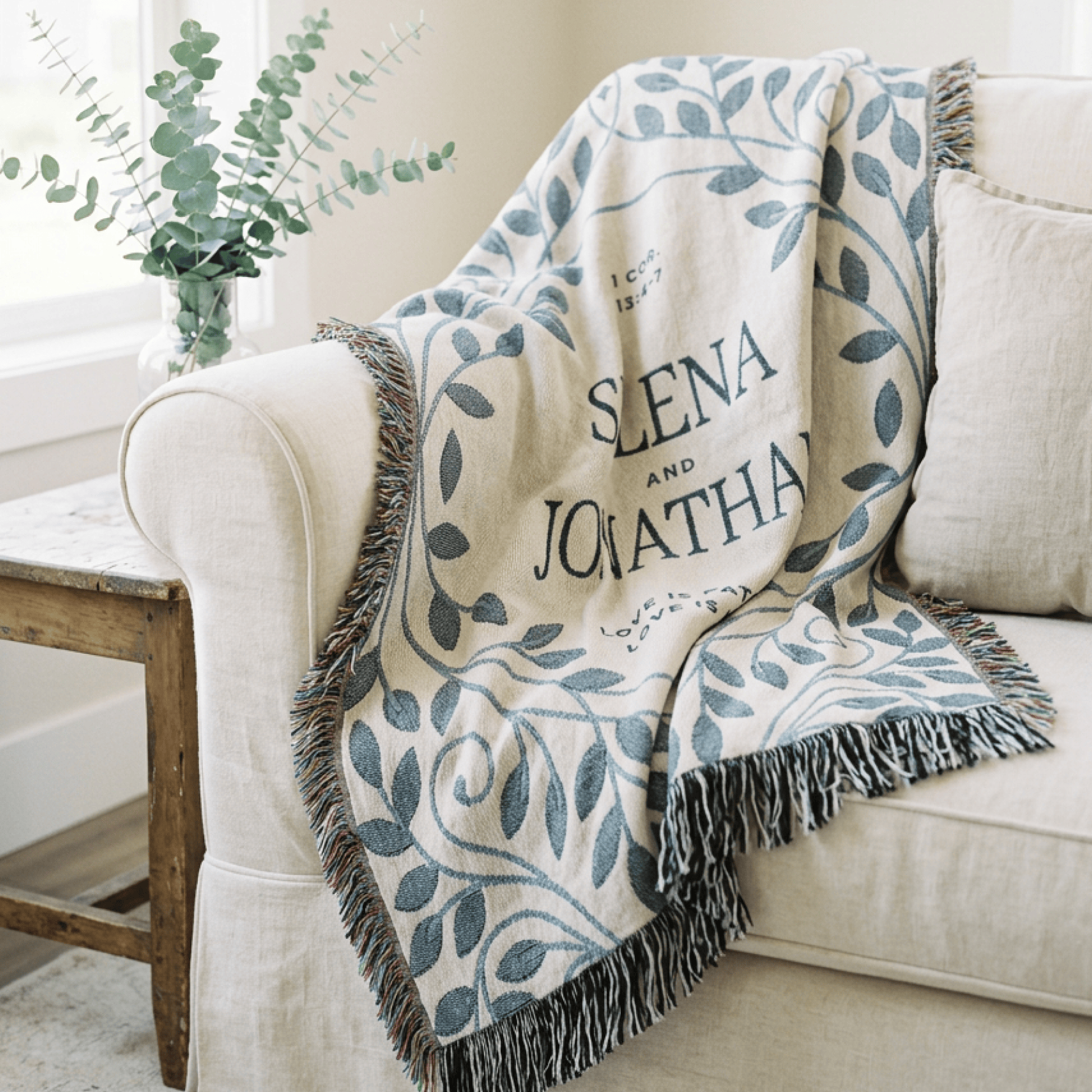 Blanket with 'Siena and Jonathan' text draped over a sofa in a cozy living room.