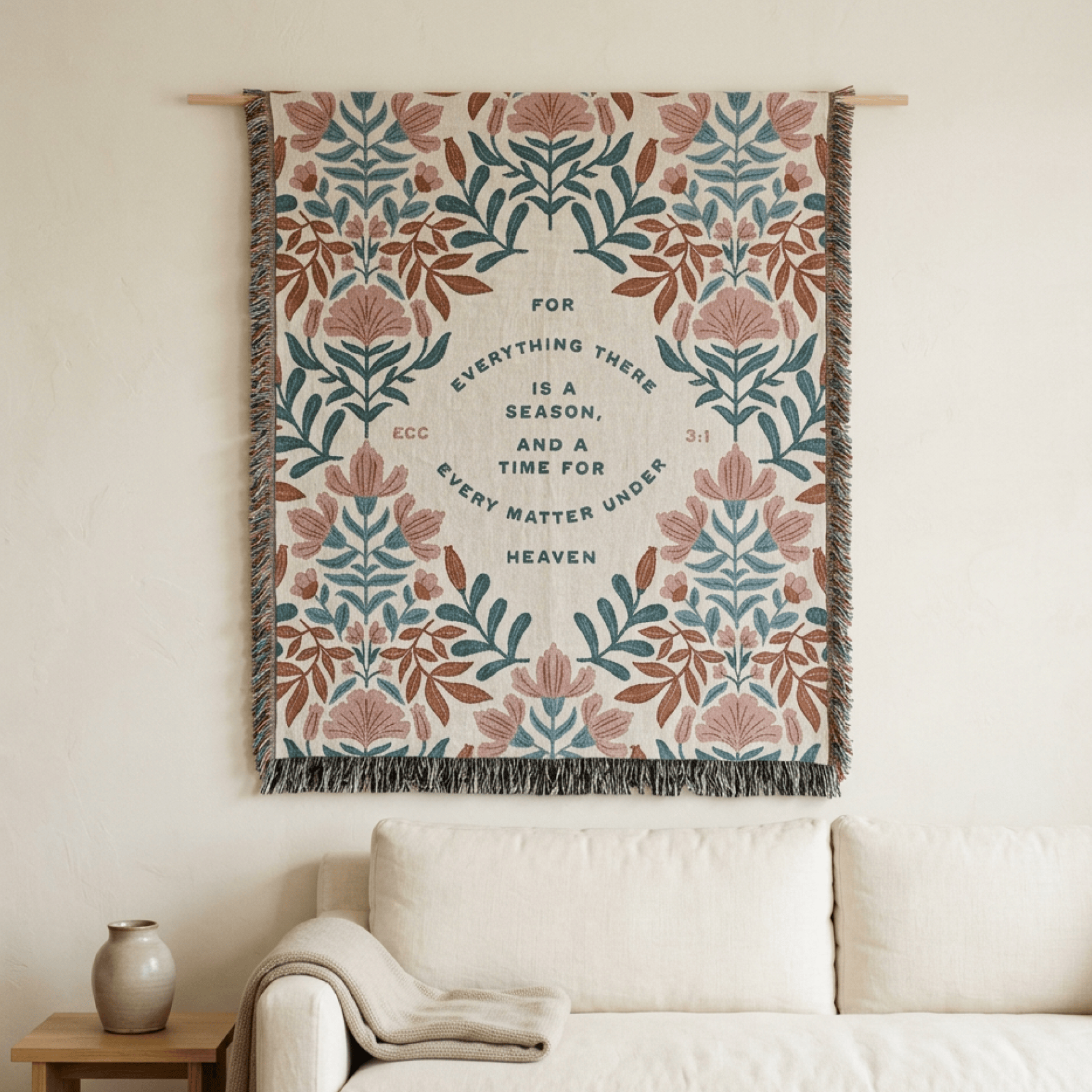 Decorative wall hanging with floral pattern and text above a sofa