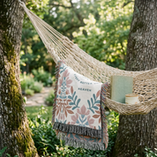 Hammock with a decorative pillow and book in a natural setting