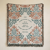Floral patterned throw blanket with text on a beige background