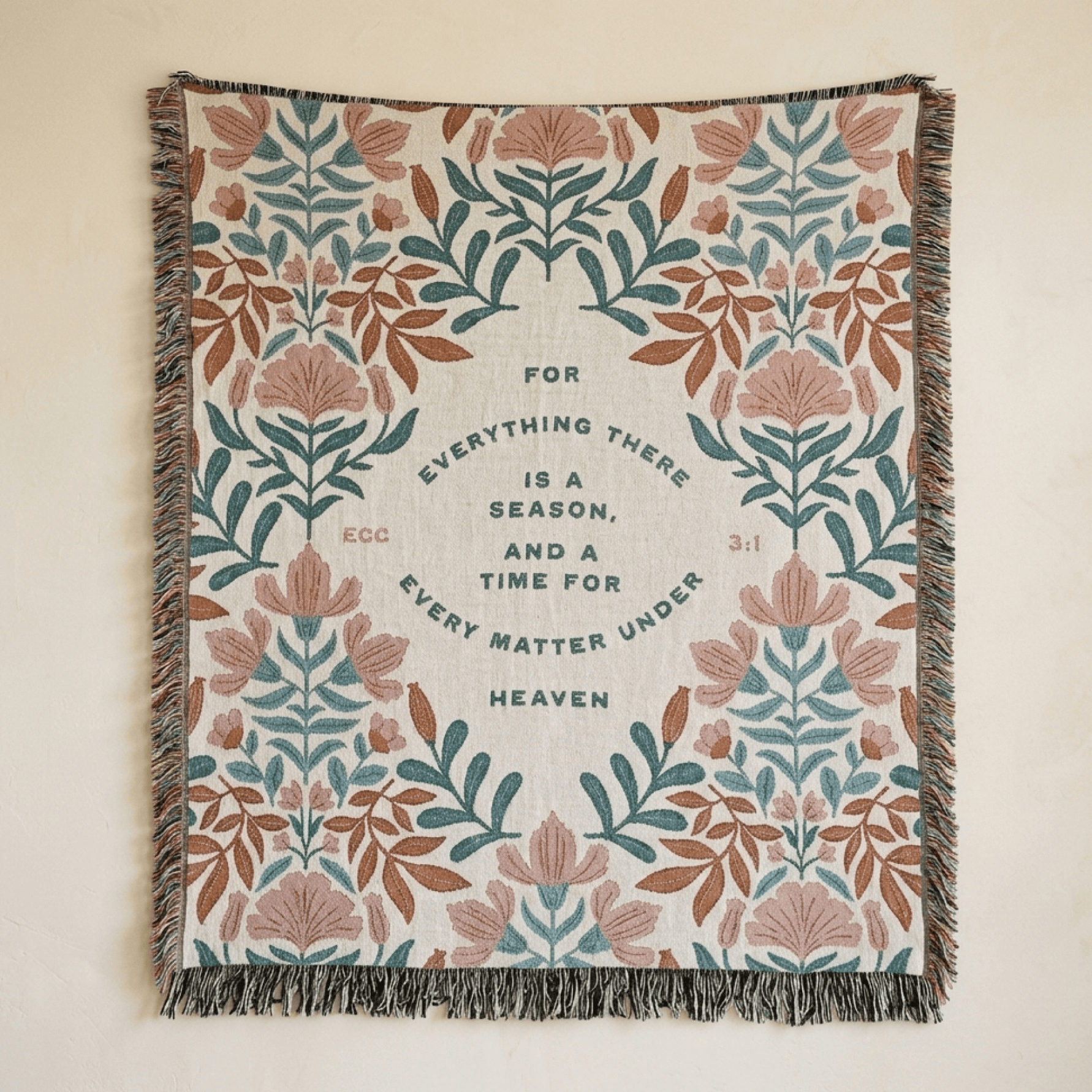 Floral patterned throw blanket with text on a beige background
