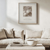 Beige sofa with a coffee table and framed artwork on a wall in a living room setting.