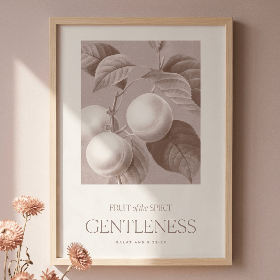 Framed artwork with fruit illustration and 'Fruit of the Spirit: Gentleness' text on a wall.