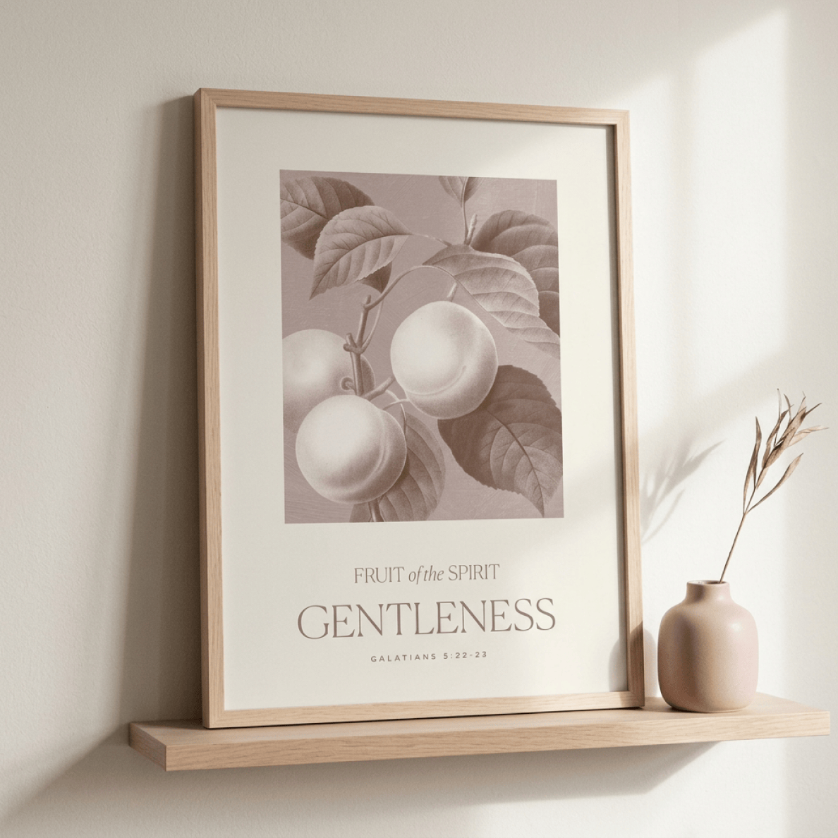 Framed artwork with apples and text on a wall shelf