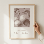 Framed artwork with 'Fruit of the Spirit: Gentleness' text and botanical design on a light background.