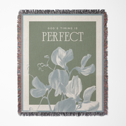 Throw blanket with floral design and motivational quote on a white background