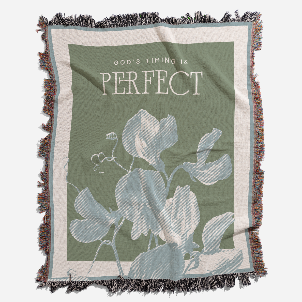 Blanket with floral design and 'God's Timing is Perfect' text on a green background