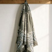 Christian woven blanket hanging vertically showing full length fringe and scripture text
