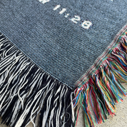 Textile with colorful fringes on a textured surface